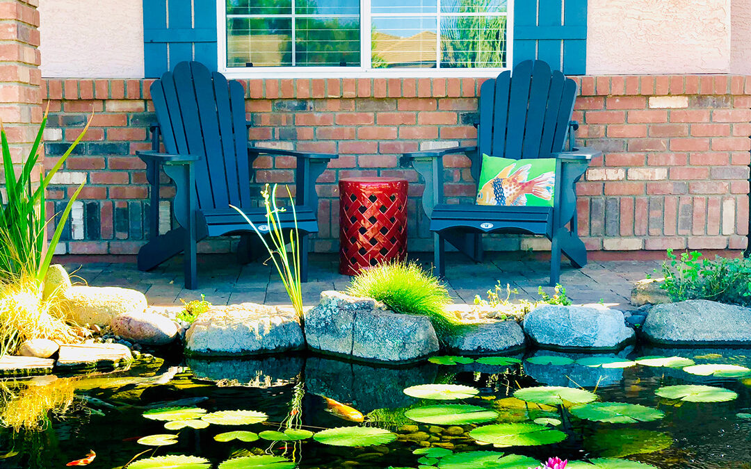 A pond with lilypads and several chairs
