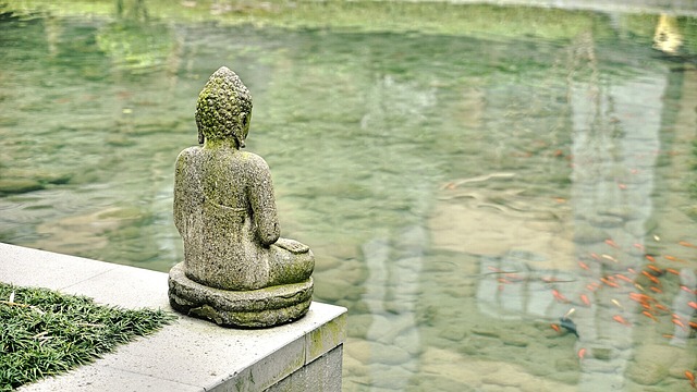 Statue of the Buddha overlooking a pond