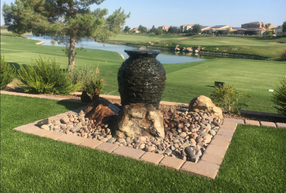 a fountain in a grassy area