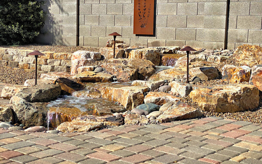 A landscaped garden with a small rock waterfall feature