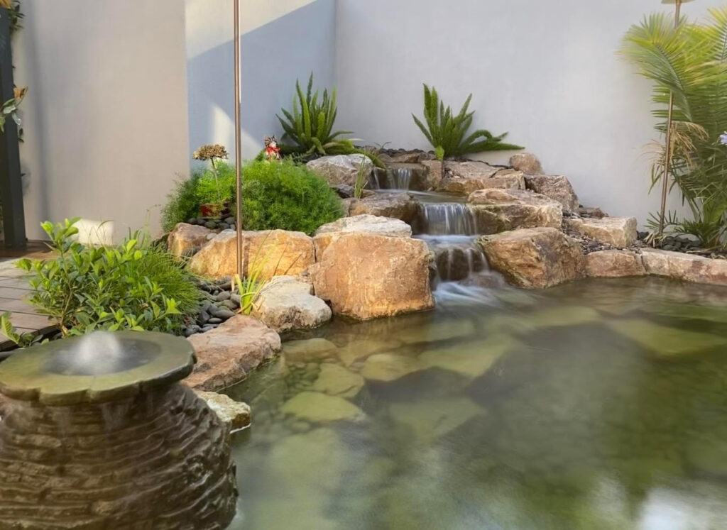 Koi Pond with Bridge to House with Flags