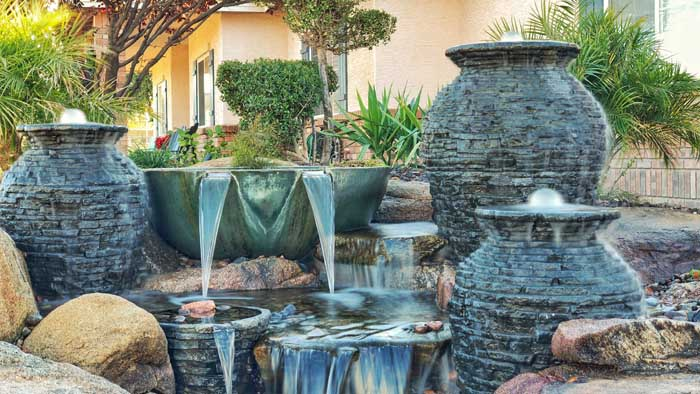 A fountainscape with multiple styles and sizes of fountain all flowing.