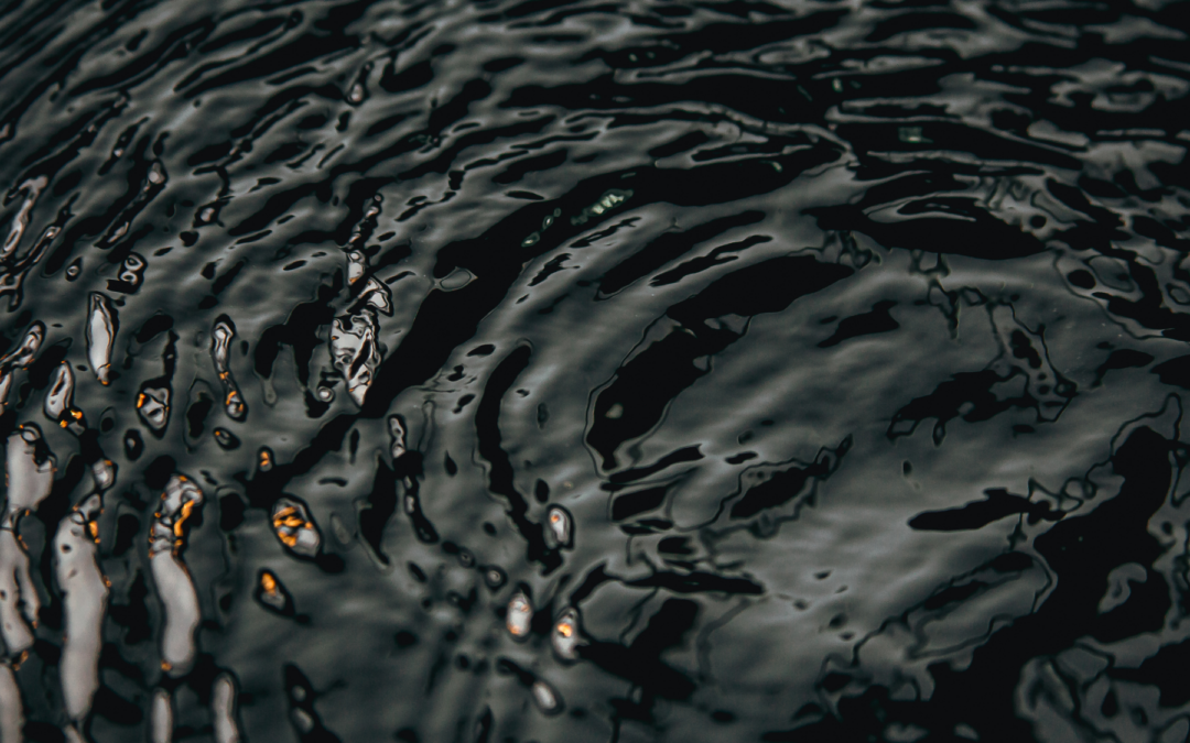 The surface of a pond rippling from the pressure of a working aerator.